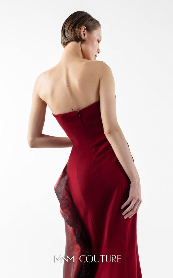 MNM Couture Style G2037 showcasing a strapless burgundy crepe gown with a sculpted, layered lamé organza bodice, a flowing train, and a high slit. | Couture Shop LA