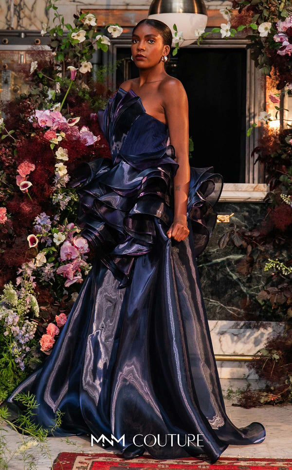 Strapless evening gown MNM Couture Style G2146 with cascading purple and navy fluid organza and a 3D floral waist bloom