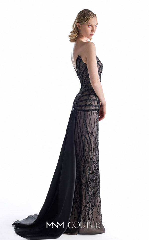 MNM Couture G2200 black sheer lace column gown with pointed sweetheart neckline, strapless corset, hand-beaded geometric embroidery, low V-back, and detachable organza overskirt with cathedral train | Couture Shop LA.