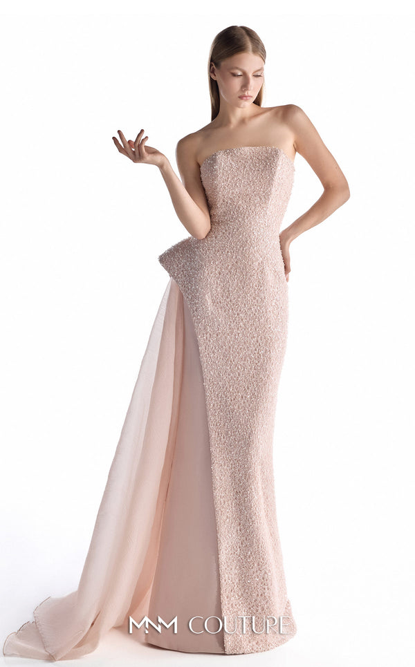 MNM Couture G2223 blush lace, crepe, and organza strapless column gown with intricate all-over embellishment, sculptural asymmetric peplum, and flowing organza overskirt with floor-length train | Couture Shop LA.