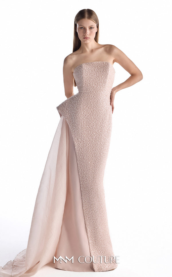 MNM Couture G2223 blush lace, crepe, and organza strapless column gown with intricate all-over embellishment, sculptural asymmetric peplum, and flowing organza overskirt with floor-length train | Couture Shop LA.