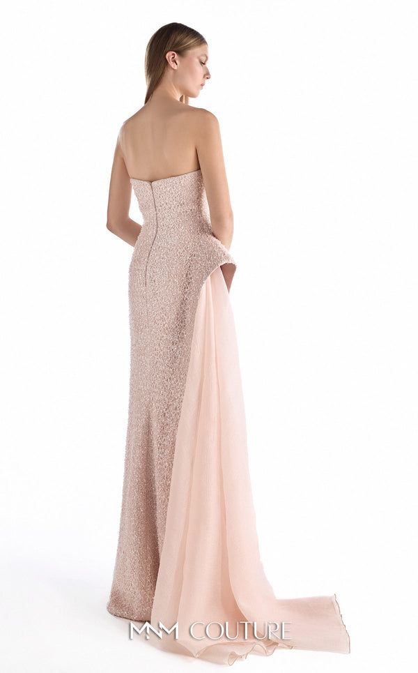 MNM Couture G2223 blush lace, crepe, and organza strapless column gown with intricate all-over embellishment, sculptural asymmetric peplum, and flowing organza overskirt with floor-length train | Couture Shop LA.