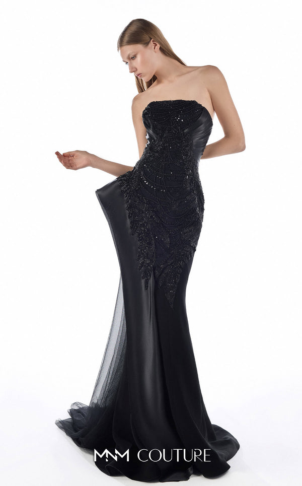 MNM Couture G2244 black beaded lace, organza, and tulle strapless fitted mermaid gown with sculpted neckline, architectural side peplum, and flowing tulle train | Couture Shop LA.