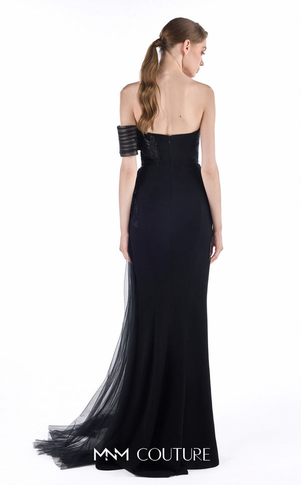 MNM Couture G2246 black beaded lace, crepe, and tulle off-shoulder sheath gown with sheer striped tulle detail, thigh-high front slit, and soft tulle train | Couture Shop LA.