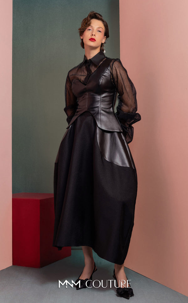 MNM Couture GOF2520 two-piece ensemble, featuring a black one-shoulder faux leather top and a matching black mikado piqué A-line skirt with leather side inserts. | Couture Shop LA