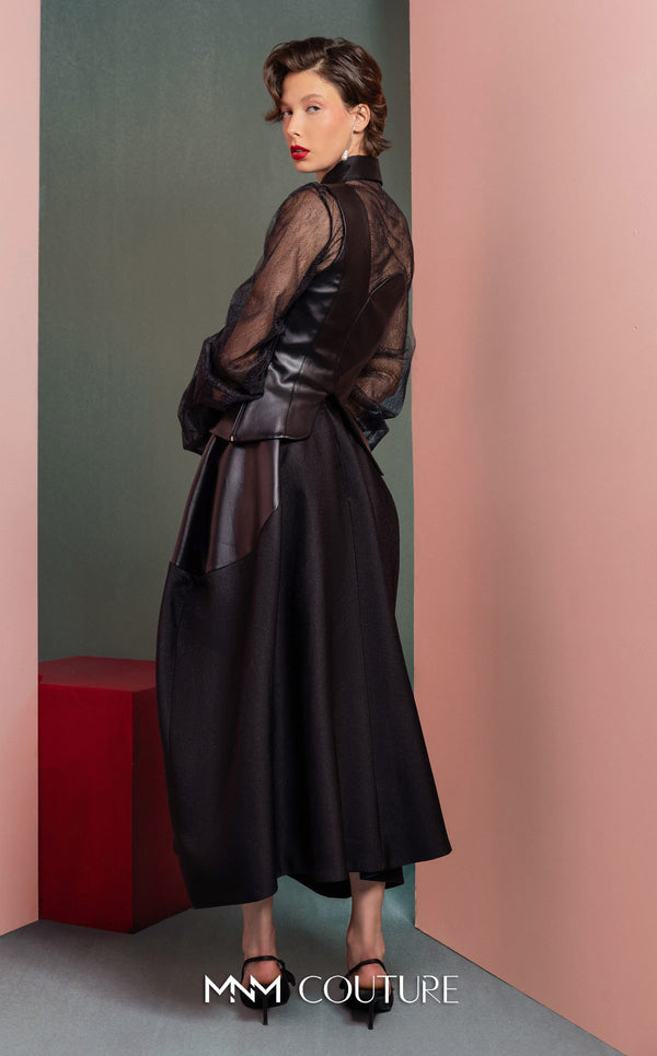 MNM Couture GOF2520 two-piece ensemble, featuring a black one-shoulder faux leather top and a matching black mikado piqué A-line skirt with leather side inserts. | Couture Shop LA