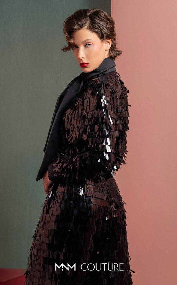 MNM Couture GOF2526 two-piece black sequin ensemble, featuring a long-sleeve blouse with a large taffeta bow at the neck and matching flared sequin pants. | Couture Shop LA