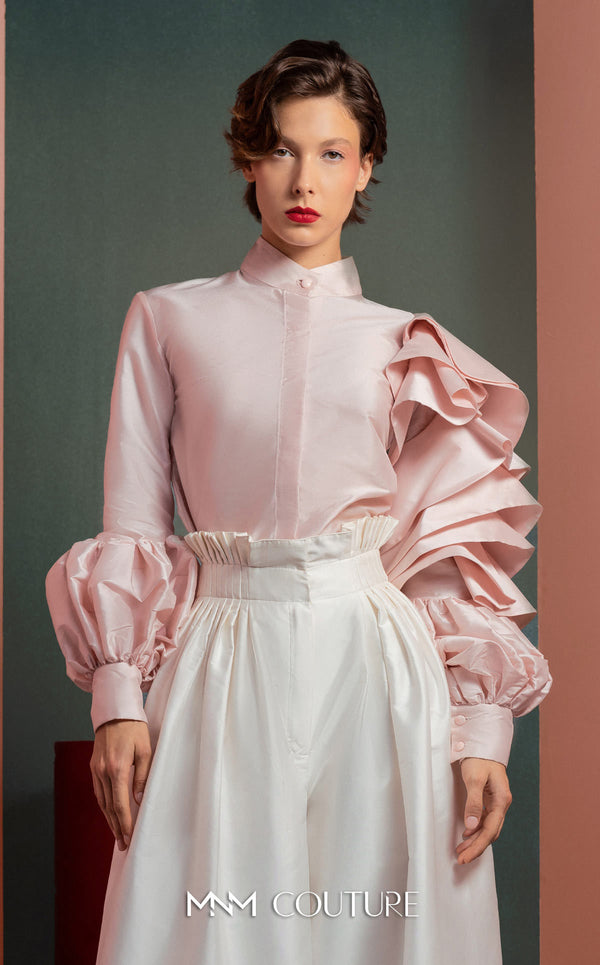 MNM Couture GOF2529 two-piece ensemble, featuring high-waisted white taffeta wide-leg pants and a tailored soft pink blouse with intricate ruffled sleeves. | Couture Shop LA