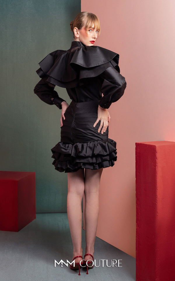 MNM Couture GOF2539 two-piece ensemble in black taffeta, featuring a dramatic ruffled blouse with sheer neckline accents and a matching ruched skirt with a ruffled hem. | Couture Shop LA