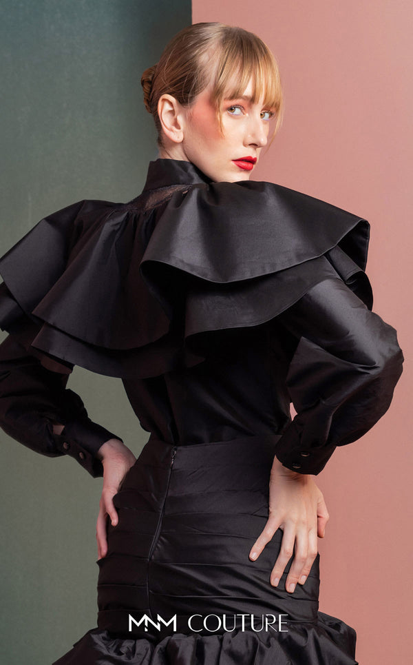 MNM Couture GOF2539 two-piece ensemble in black taffeta, featuring a dramatic ruffled blouse with sheer neckline accents and a matching ruched skirt with a ruffled hem. | Couture Shop LA