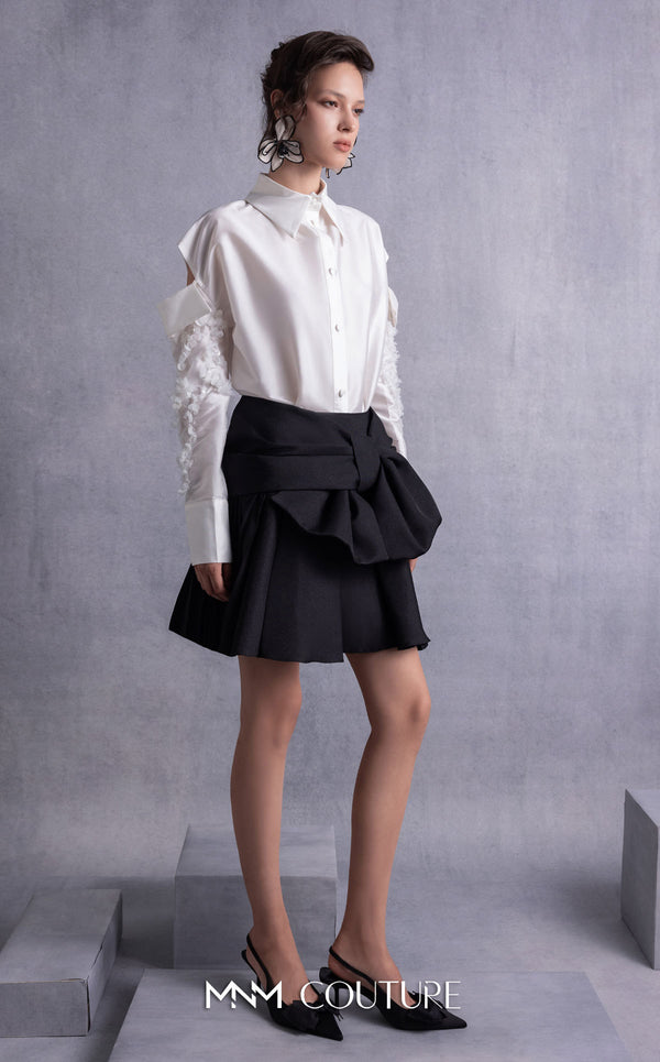 MNM Couture GOS2519 Black piqué skirt with bow design and off-white taffeta blouse with embroidered sleeves and cut-out shoulders. | Couture Shop LA