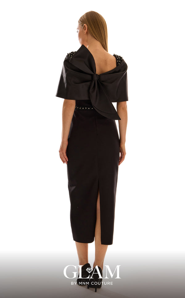 MNM Couture H09683 black satin mikado midi dress with off-shoulder capelet, crystal and pearl shoulder clusters, crystal rhinestone waistband, and oversized structured bow at center back | Couture Shop LA