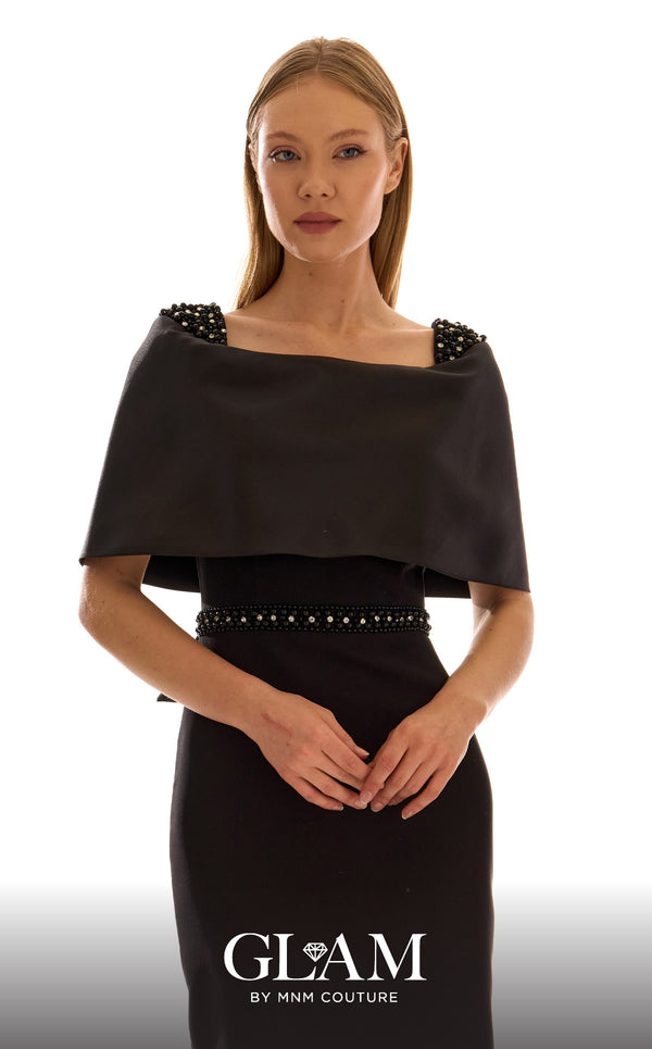 MNM Couture H09683 black satin mikado midi dress with off-shoulder capelet, crystal and pearl shoulder clusters, crystal rhinestone waistband, and oversized structured bow at center back | Couture Shop LA