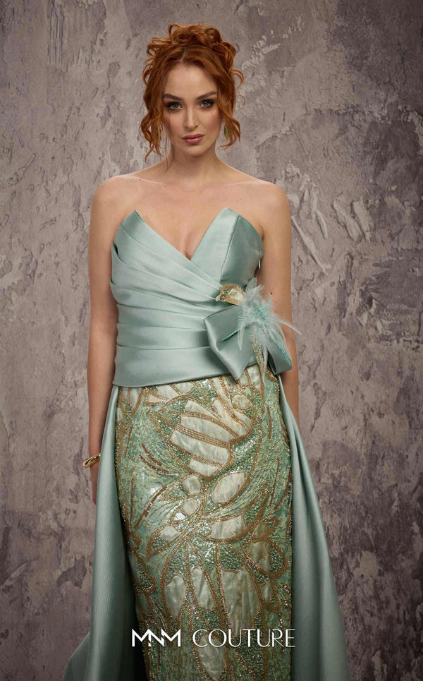 MNM Couture Style J03497 strapless column gown with a beaded skirt, satin train, and asymmetrical deep V-neck. \ Couture Shop LA