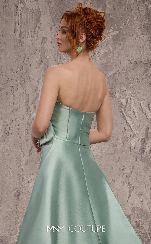MNM Couture Style J03497 strapless column gown with a beaded skirt, satin train, and asymmetrical deep V-neck. \ Couture Shop LA