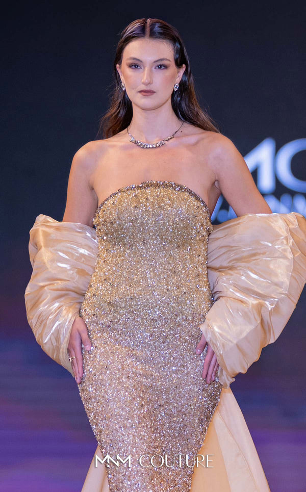 MNM Couture Style M1010 showcasing a sleeveless mermaid gown covered in gradient sequins and beading, with a round neckline and a removable long cape. | Couture Shop LA