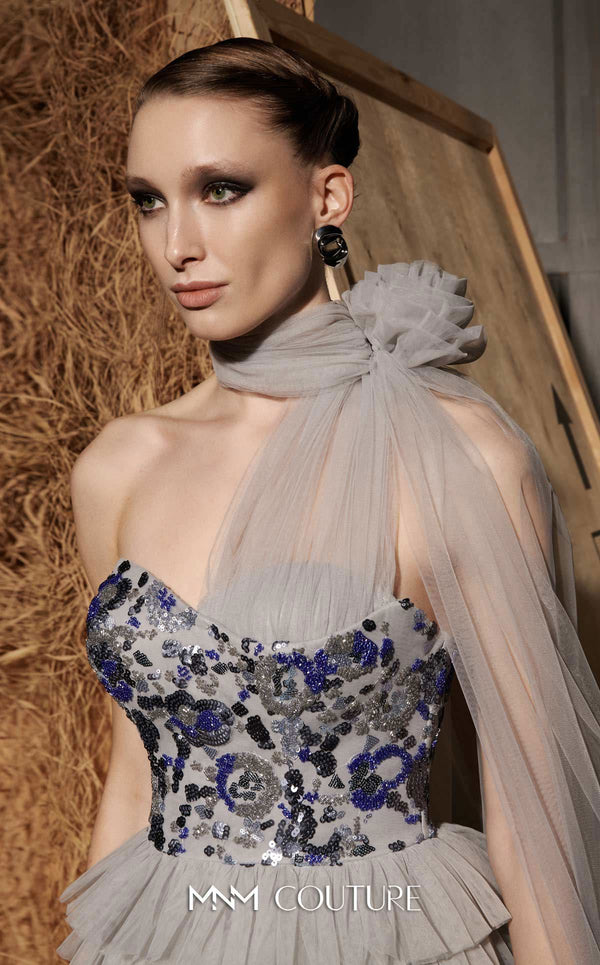 MNM Couture Style N0641 silver column maxi dress with corset-style embroidered bodice, sequins, layered organza skirt, flower-shaped neckline detail, and long train | Couture Shop LA