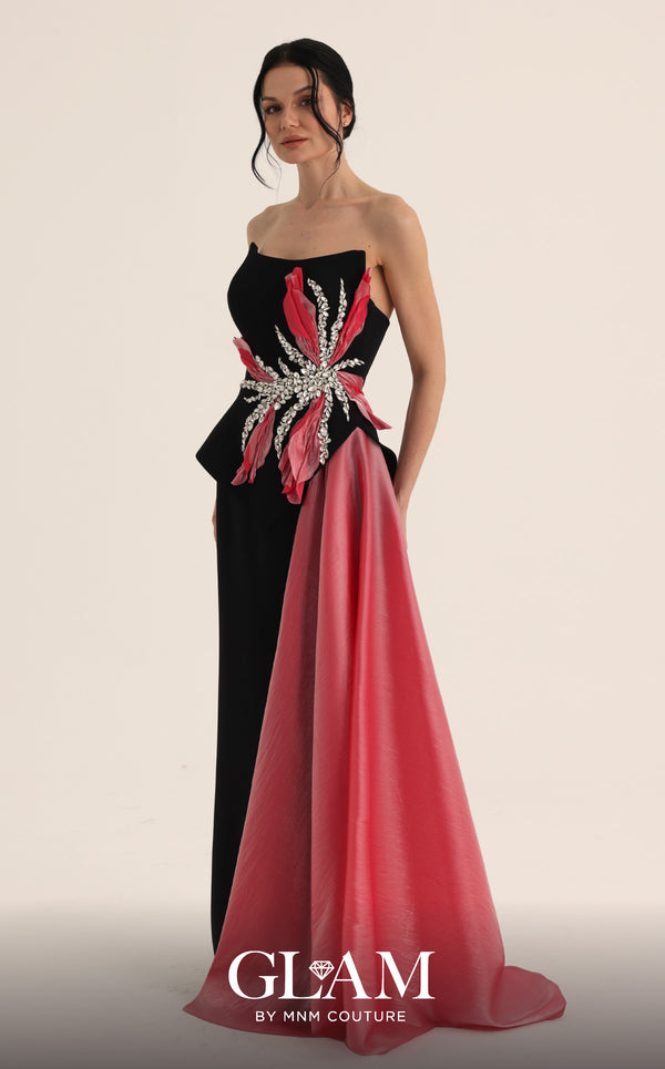 MNM Couture O07806 black crepe strapless column gown with oversized 3D fuchsia floral crystal starburst bodice, triangular peplum with inverted V open back, and sweeping fuchsia organza panel | Couture Shop LA