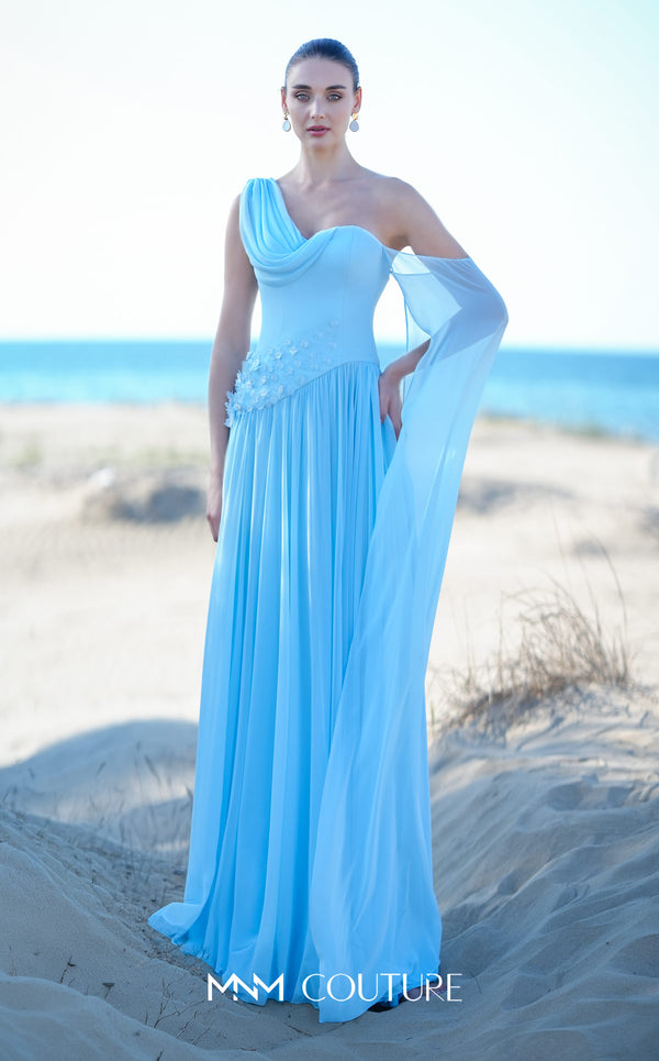 MNM Couture O09003 sky blue one-shoulder Grecian chiffon gown with soft cowl drape, 3D floral cluster at the right hip, densely pleated A-line skirt, and long flowing arm veil | Couture Shop LA