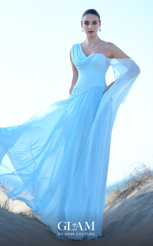MNM Couture O09003 sky blue one-shoulder Grecian chiffon gown with soft cowl drape, 3D floral cluster at the right hip, densely pleated A-line skirt, and long flowing arm veil | Couture Shop LA
