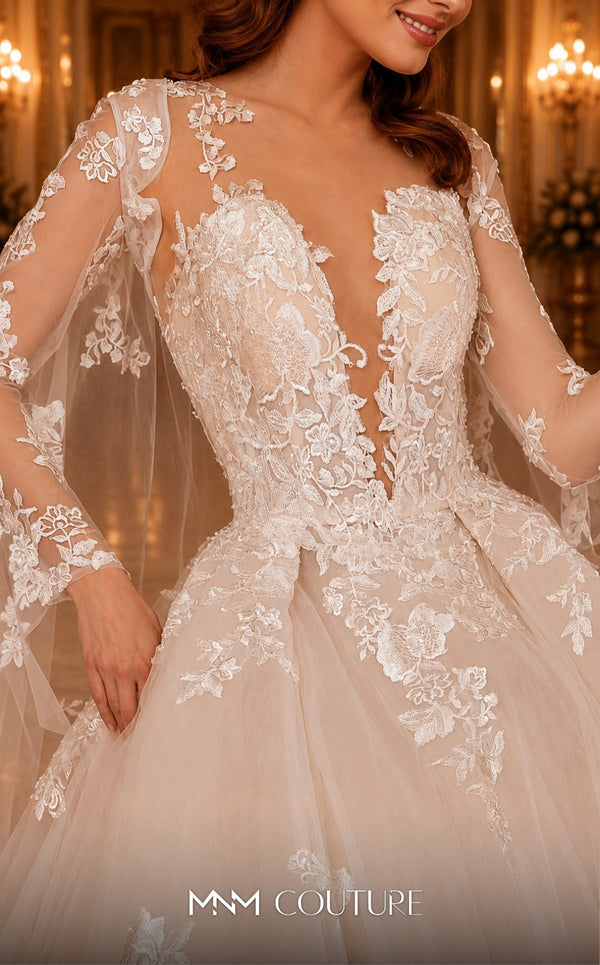 MNM Couture W2108 princess gown with removable tulle cape, lace appliques, and deep V-neckline details. | Couture Shop LA