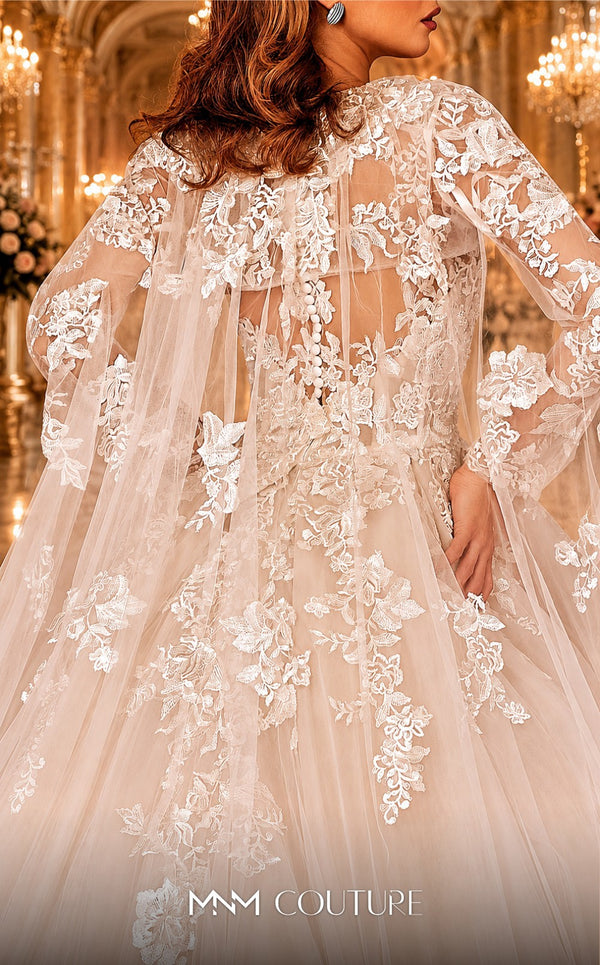 MNM Couture W2108 princess gown with removable tulle cape, lace appliques, and deep V-neckline details. | Couture Shop LA