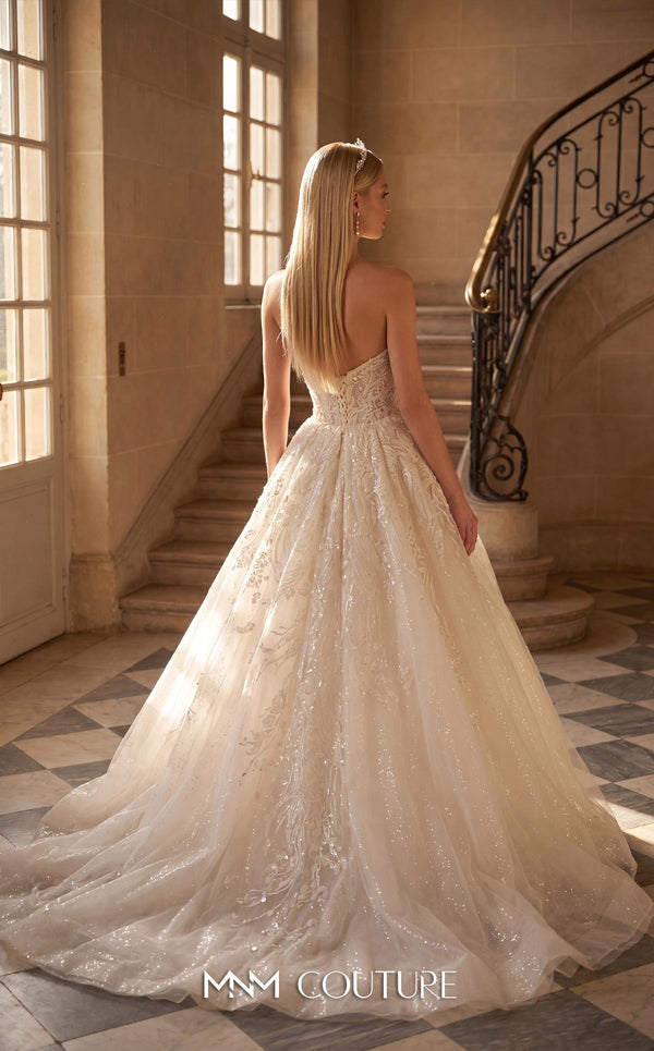 MNM Couture W2302 white strapless sweetheart ball gown wedding dress with dense floral lace bodice, four vertical lace trails down the tulle skirt, very low open back with corset lace-up closure, and cathedral train | Couture Shop LA