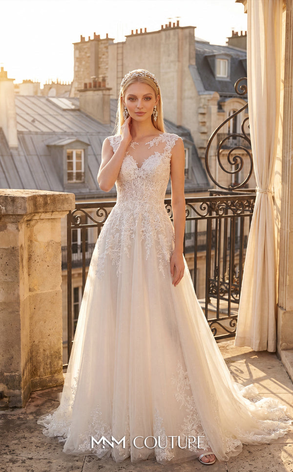 MNM Couture W2304 white A-line wedding dress with illusion scoop neckline, wide sheer 3D lace shoulder panels, lace bodice through the hip, clean tulle skirt with lace hem border, open center back, and sweep train | Couture Shop LA