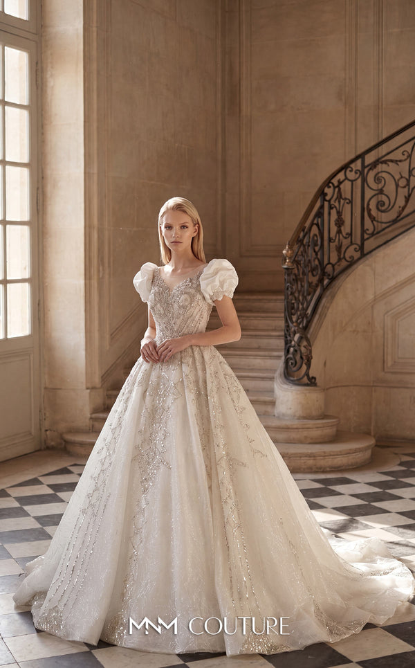 MNM Couture W2312 white sweetheart ball gown wedding dress with short structured puff sleeves, diagonal swirling crystal-beaded bodice with center medallion, low open corset back, and voluminous tulle skirt with swirling lace appliqués and cathedral train | Couture Shop LA