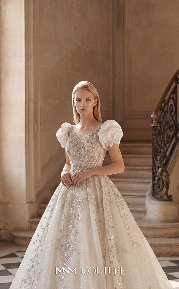 MNM Couture W2312 white sweetheart ball gown wedding dress with short structured puff sleeves, diagonal swirling crystal-beaded bodice with center medallion, low open corset back, and voluminous tulle skirt with swirling lace appliqués and cathedral train | Couture Shop LA