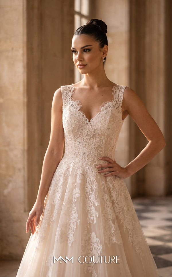MNM Couture W3580 champagne A-line wedding dress with deep V-neckline, thin spaghetti straps, dramatically deep V open back, scattered 3D floral lace appliqués, and flowing tulle skirt with sweep train | Couture Shop LA