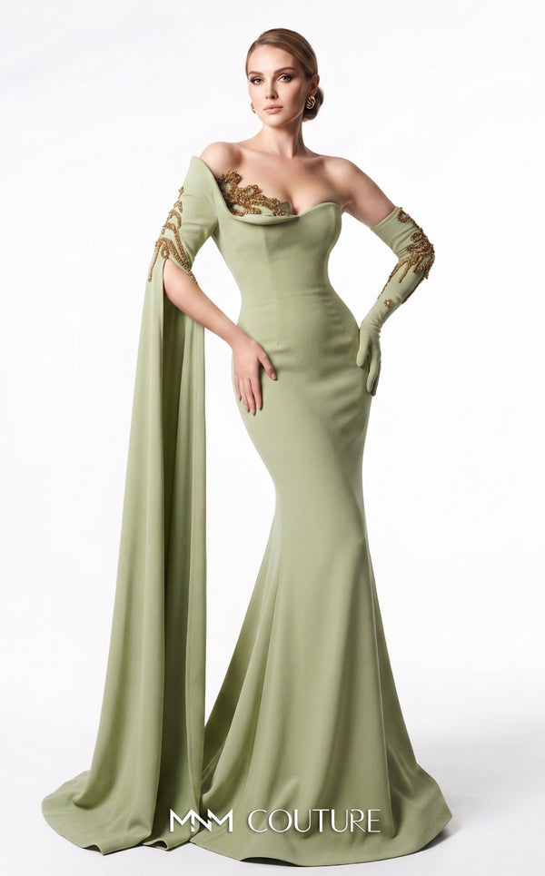 MNM Couture 2606A black stretch crepe off-shoulder mermaid gown with sweetheart neckline, left sheer illusion glove sleeve in gold metallic floral lace, right floor-length crepe cape drape with gold lace, open upper back, and sweep train | Couture Shop LA