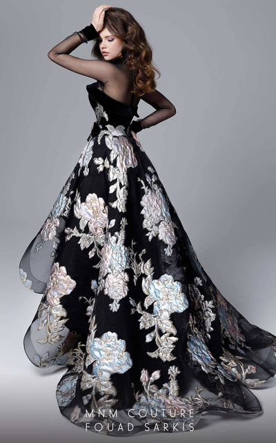 A fashion-forward MNM Couture 2715 high-low A-line gown with sheer long sleeves, a close neckline, and embossed print details, sweeping into a dramatic train. | Couture Shop LA
