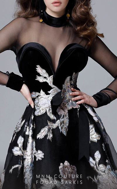 A fashion-forward MNM Couture 2715 high-low A-line gown with sheer long sleeves, a close neckline, and embossed print details, sweeping into a dramatic train. | Couture Shop LA