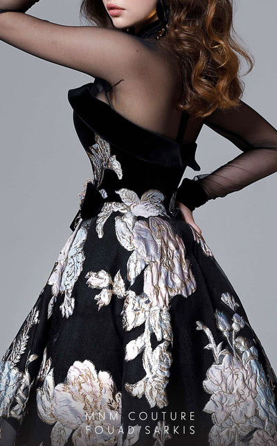 A fashion-forward MNM Couture 2715 high-low A-line gown with sheer long sleeves, a close neckline, and embossed print details, sweeping into a dramatic train. | Couture Shop LA