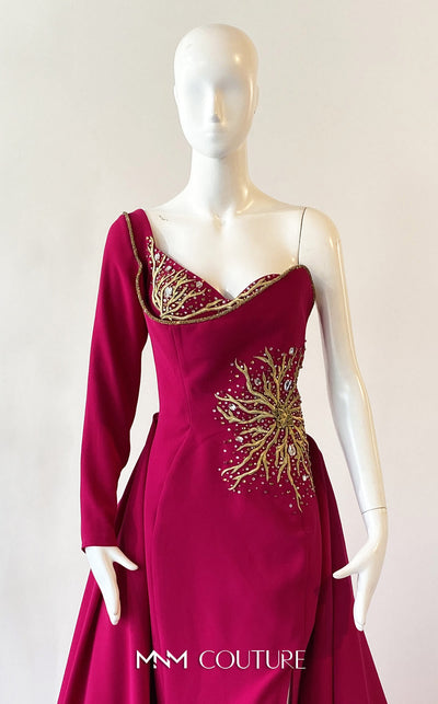 A sophisticated MNM Couture 2719 gown with a sweetheart neckline, beaded one long sleeve, high slit, detachable overskirt, and sweeping train. | Couture Shop LA