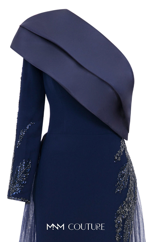 MNM Couture Style B1125 featuring a green organza gown with strap sleeves, a floral-embellished strap, cascading pleats, a V-neckline, and a flowing train.| Couture Shop LA.