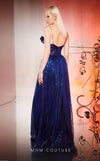 MNM Couture Style E0049 in royal blue, showcasing an A-line silhouette in embroidered mesh, an asymmetric neckline with a knot, spaghetti straps, and a dramatic back skirt. | Couture Shop LA.
