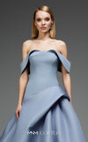 MNM Couture Style E0103 in ice blue, featuring an A-line silhouette with a pleated off-the-shoulder neckline, a fitted corset bodice, and a draped sash at the waist.| Couture Shop LA
