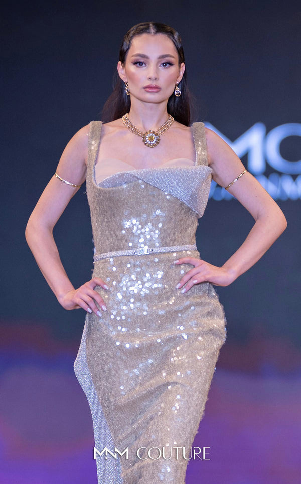 MNM Couture E0108 sequin-embellished fitted column gown with strap sleeves, asymmetric sweetheart neckline, and a flowing cape with a train. | Couture Shop LA