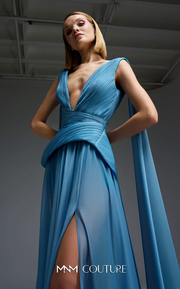 MNM Couture Style E0121 featuring a blue organza gown with a deep V-neckline, pleated corset-style bodice, an asymmetric peplum detail, and a long train. | Couture Shop LA