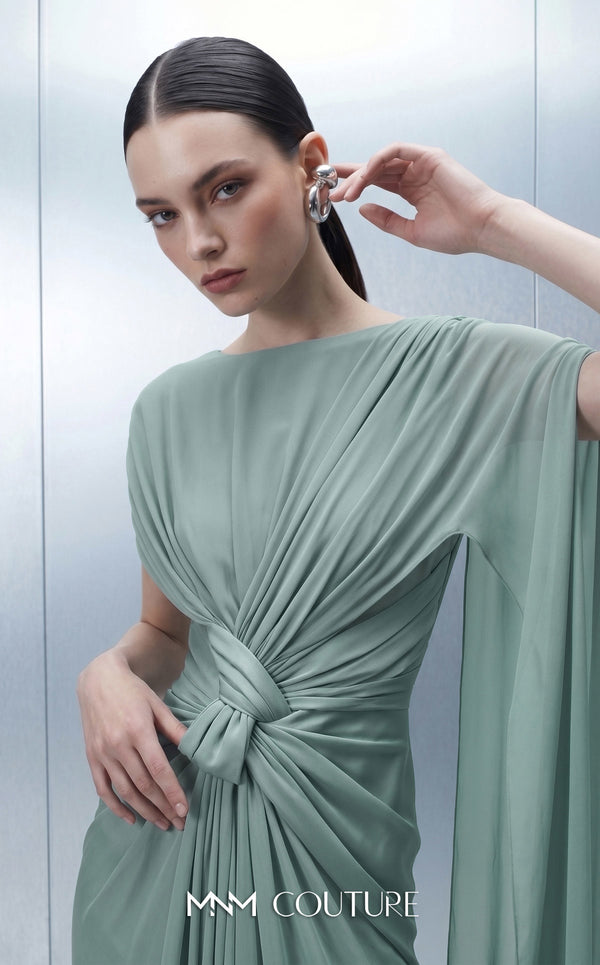 MNM Couture E0160 satin and chiffon draped column gown with asymmetric dual sleeves, satin knot waist, cape sleeve, and back fan-pleat detail | Couture Shop LA.