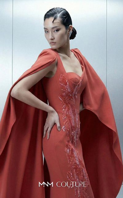 Long straight fitted crepe evening gown with an asymmetrical design and removable cape showcasing MNM Couture Style E0164 | Couture Shop LA.