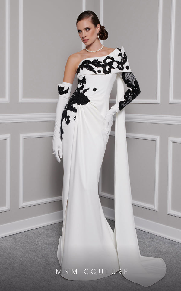 Elegant MNM Couture F02803 evening gown featuring a strapless, off-shoulder design with a single long sleeve, adorned with intricate beading and tassels | Couture Shop LA