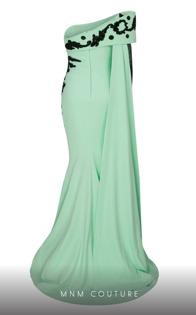 Elegant MNM Couture F02803 evening gown featuring a strapless, off-shoulder design with a single long sleeve, adorned with intricate beading and tassels | Couture Shop LA