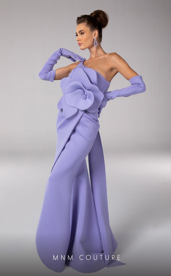 Discover the essence of evening sophistication with the MNM Couture F02826, a luxurious crepe gown embellished with a classical rose, tailored for the exclusive tastes of red carpet and special occasion aficionados. | Couture Shop LA