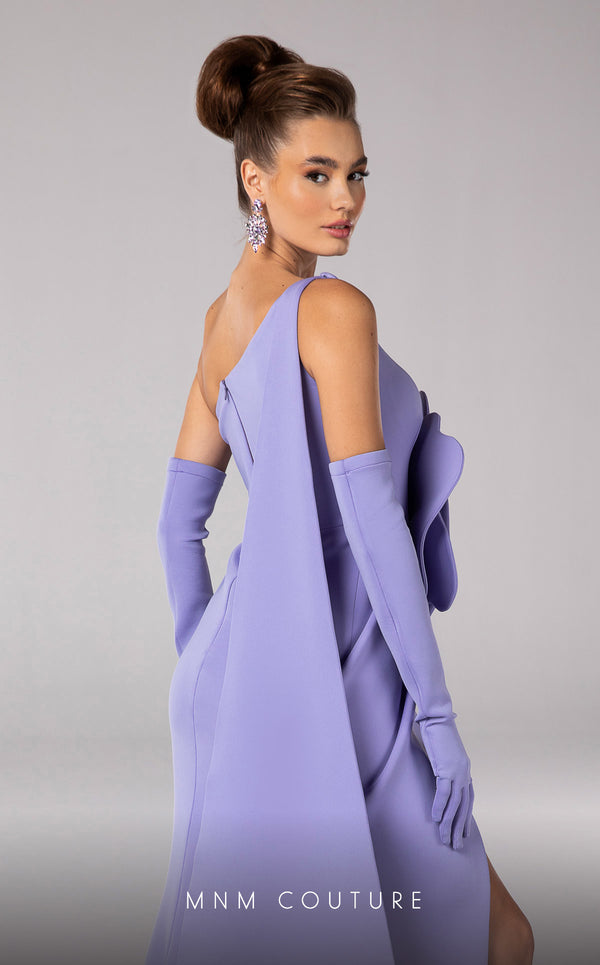 Discover the essence of evening sophistication with the MNM Couture F02826, a luxurious crepe gown embellished with a classical rose, tailored for the exclusive tastes of red carpet and special occasion aficionados. | Couture Shop LA