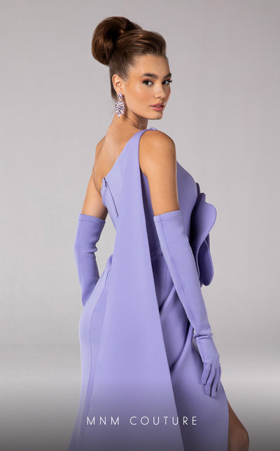 Discover the essence of evening sophistication with the MNM Couture F02826, a luxurious crepe gown embellished with a classical rose, tailored for the exclusive tastes of red carpet and special occasion aficionados. | Couture Shop LA
