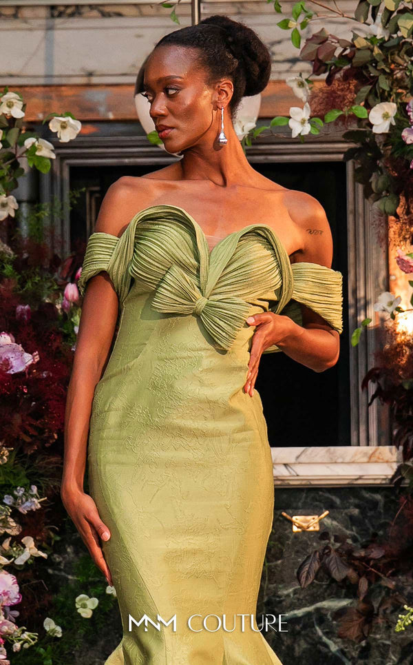 MNM Couture Style F02901 dress showcasing a pleated sweetheart neckline, mid-bow detail, and a stunning mermaid silhouette. / Couture Shop LA