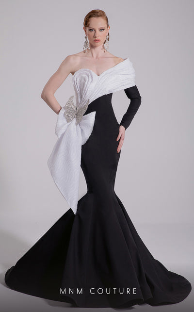 MNM Couture Style F02907 featuring an asymmetric mermaid gown with a large pleated organza bow, one off-shoulder cap sleeve, and crystal embellishments on the bodice. | Couture Shop LA